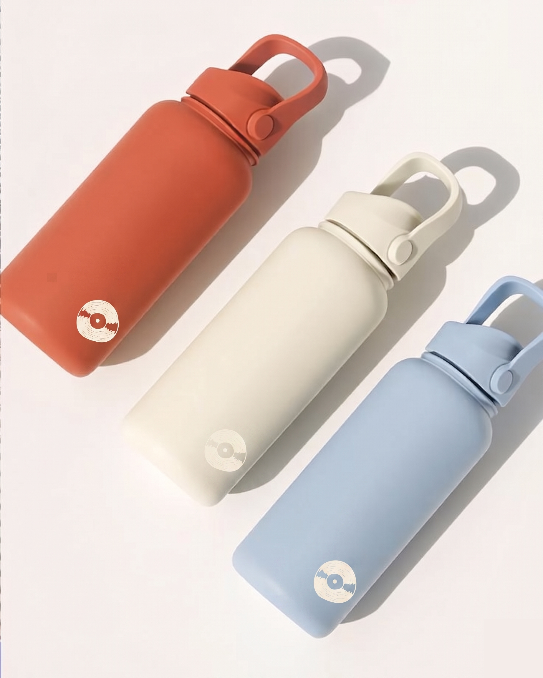 Three colorful water bottles with a brand logo on a light gray background